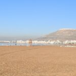 a beach with a mountain in the background