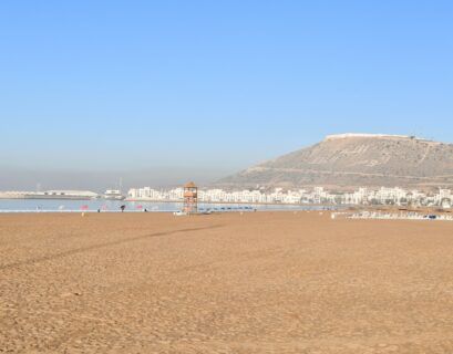 a beach with a mountain in the background