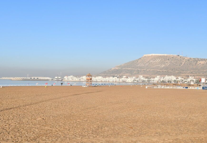 a beach with a mountain in the background