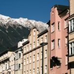 a group of buildings with a mountain in the background