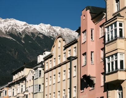 a group of buildings with a mountain in the background