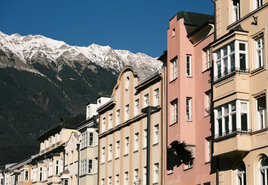 a group of buildings with a mountain in the background