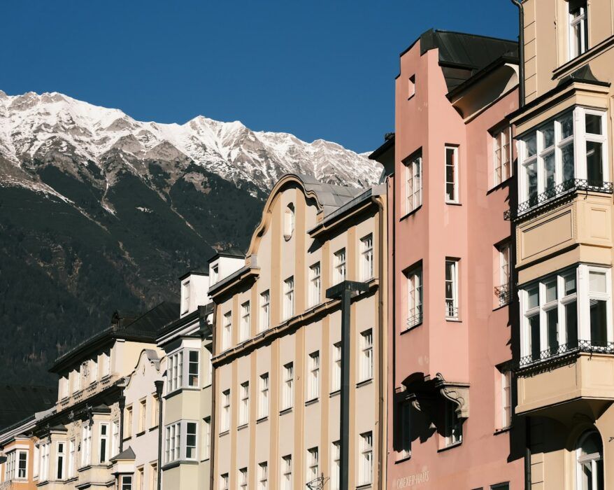 a group of buildings with a mountain in the background